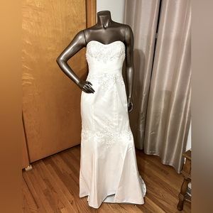 Gorgeous fit and flare soft white sweat heart strapless wedding gown.